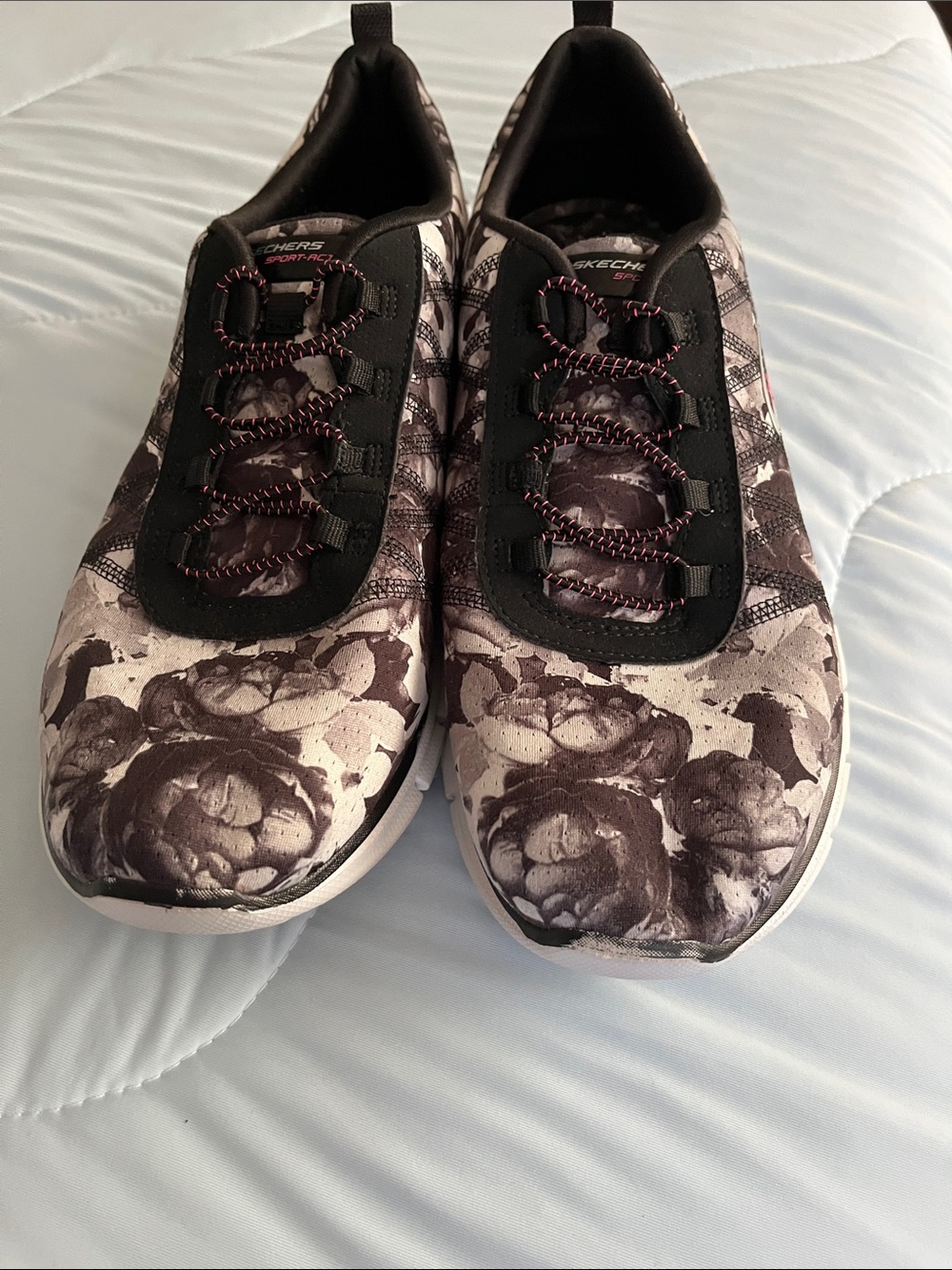 Skechers Women’s Black and Cream Floral Slip-On Sneakers